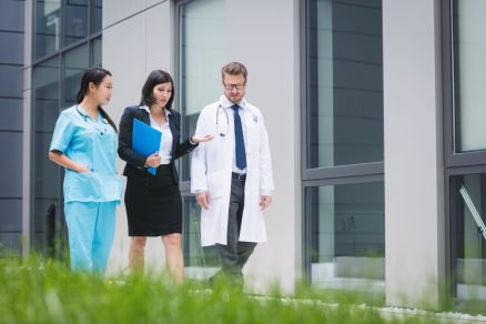 Doctors and nurse interacting while walking in hospital premises